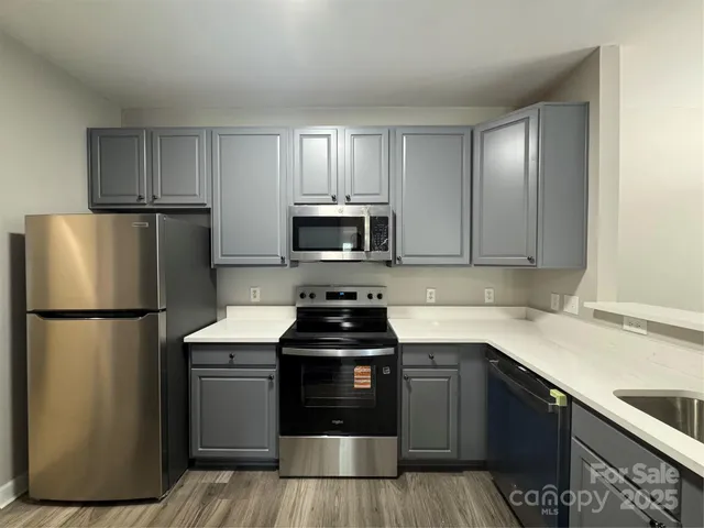 a kitchen with a refrigerator sink and microwave