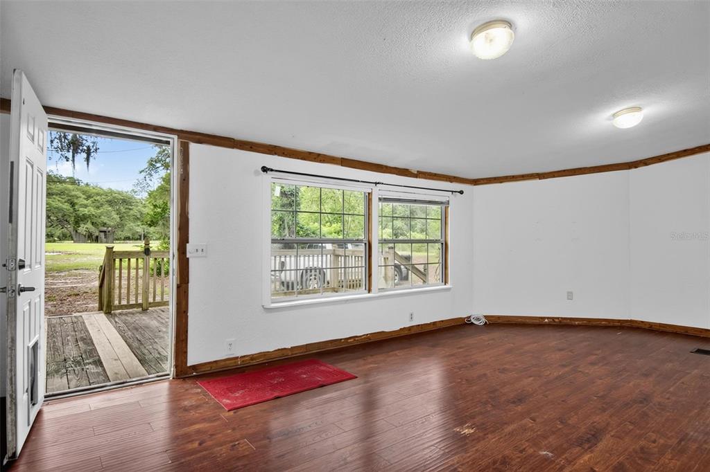 156 Kingfish Road Pomona Park, FL 32181 - Photo 15 of 55 an empty room with wooden floor and windows