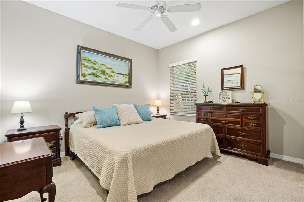 11610 Marathon Circle Venice, FL 34293 - Photo 32 of 84 a bedroom with a bed and a chandelier