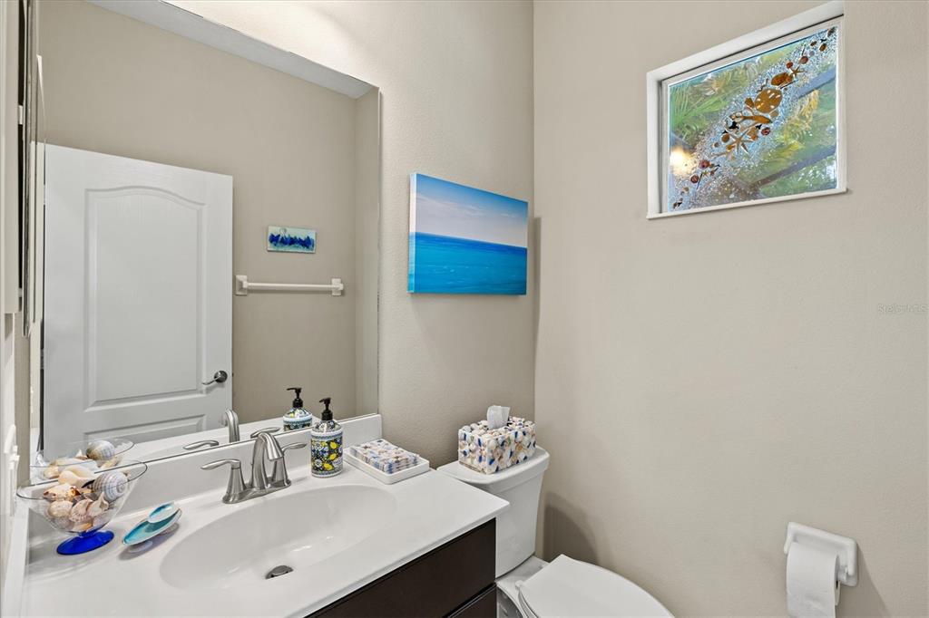 11610 Marathon Circle Venice, FL 34293 - Photo 34 of 84 a bathroom with a sink mirror and toilet