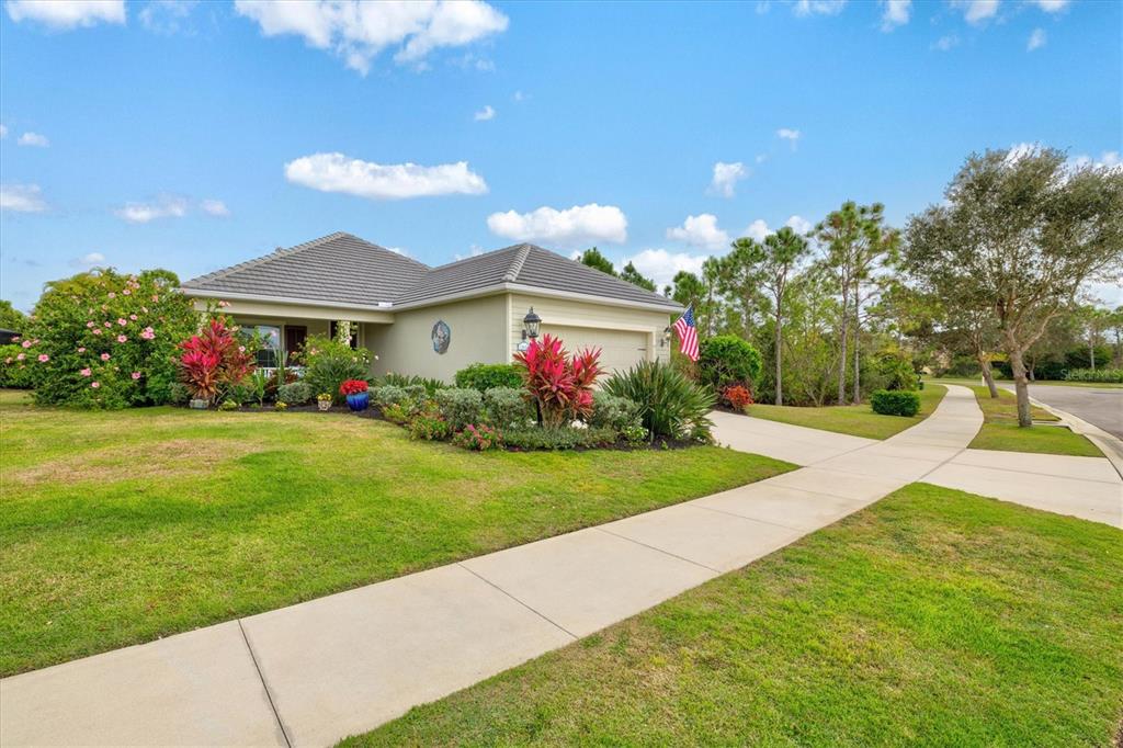 11610 Marathon Circle Venice, FL 34293 - Photo 43 of 84 a view of a house with a yard and potted plants