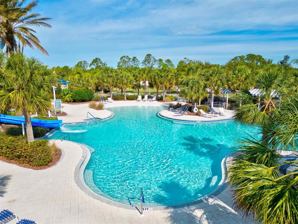 11610 Marathon Circle Venice, FL 34293 - Photo 56 of 84 a view of a swimming pool with lawn chairs under an umbrella