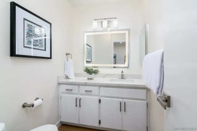 an empty room with a window and a ceiling fan
