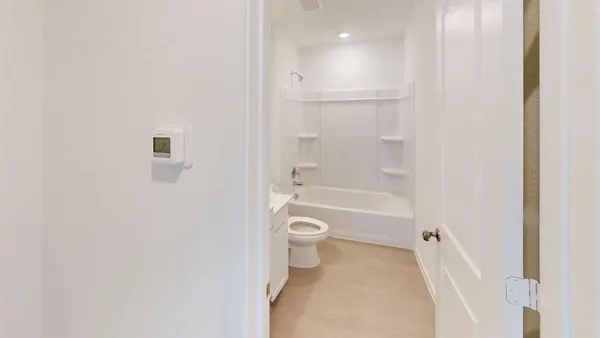 a bathroom with a granite countertop toilet a sink and a bathtub