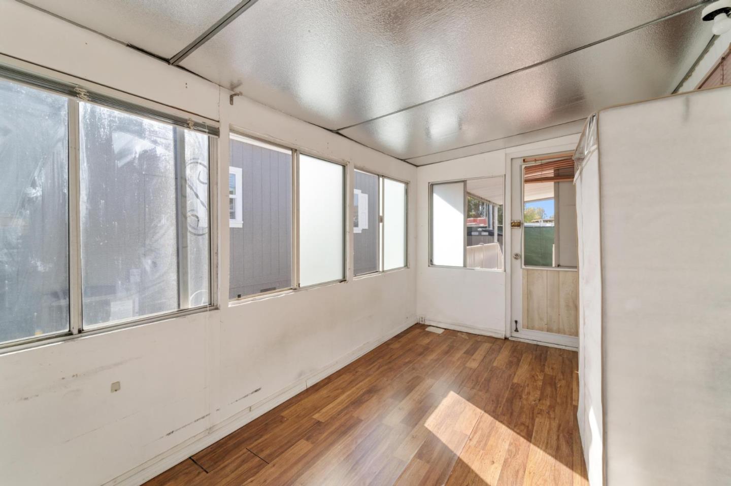 4320 Monterey Road, Unit 39 San Jose, CA 95111 - Photo 12 of 17 a view of an empty room with wooden floor and a window