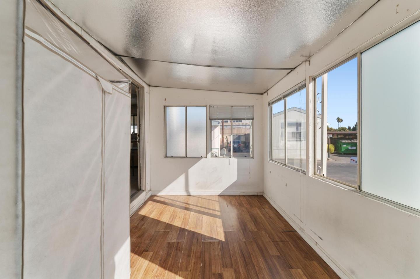 4320 Monterey Road, Unit 39 San Jose, CA 95111 - Photo 13 of 17 a view of a hallway with wooden floor and windows