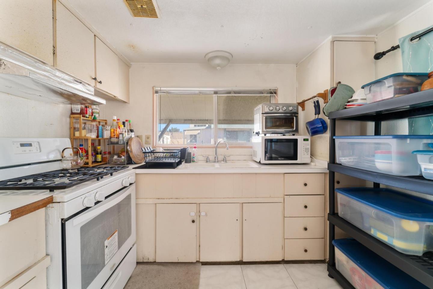 4320 Monterey Road, Unit 39 San Jose, CA 95111 - Photo 5 of 17 a kitchen with white cabinets and appliances