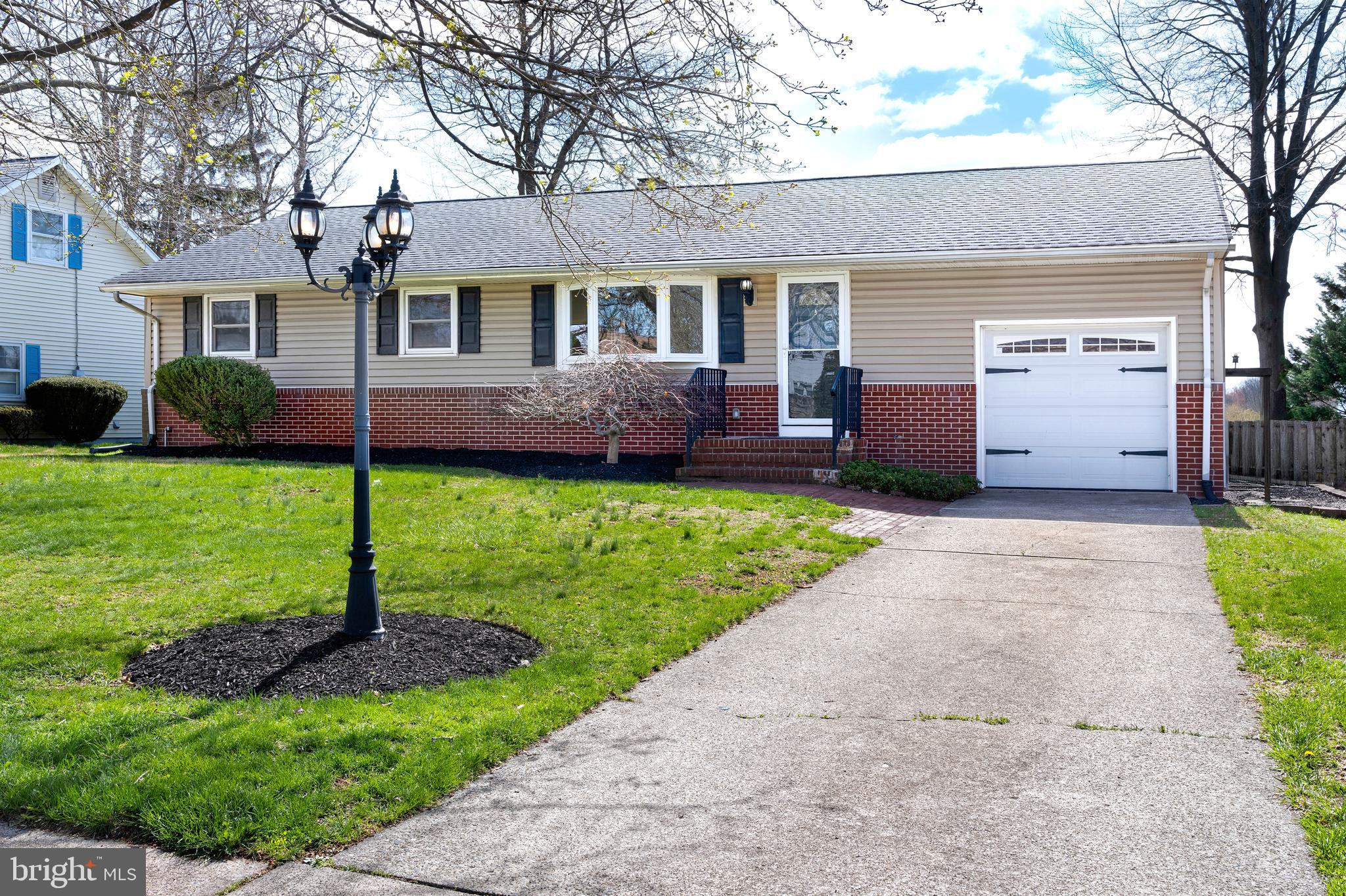 a front view of a house with a yard and outdoor seating
