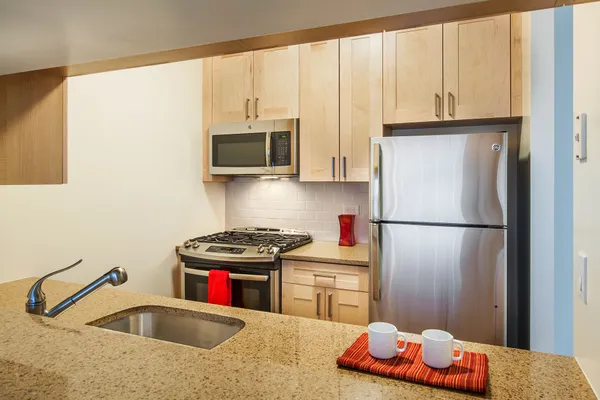a kitchen with stainless steel appliances a refrigerator sink and cabinets