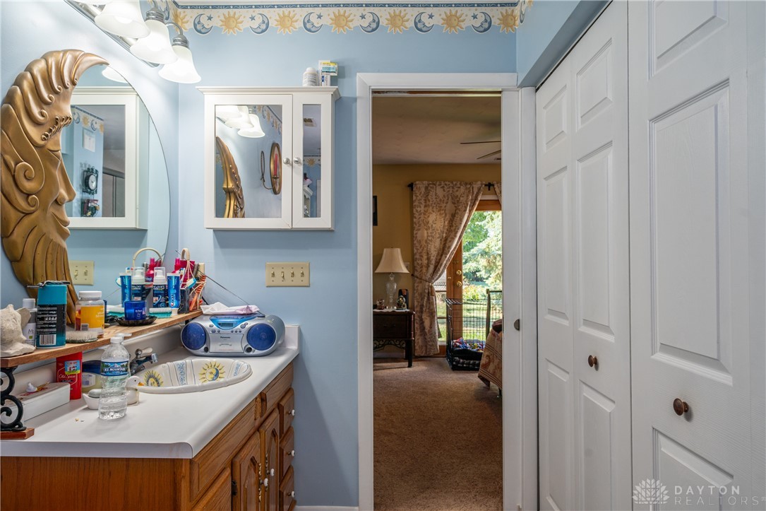 1599 Garringer Road Jamestown, OH 45335 - Photo 19 of 73 This bathroom features a single vanity with ample counter space and a classic mirror.