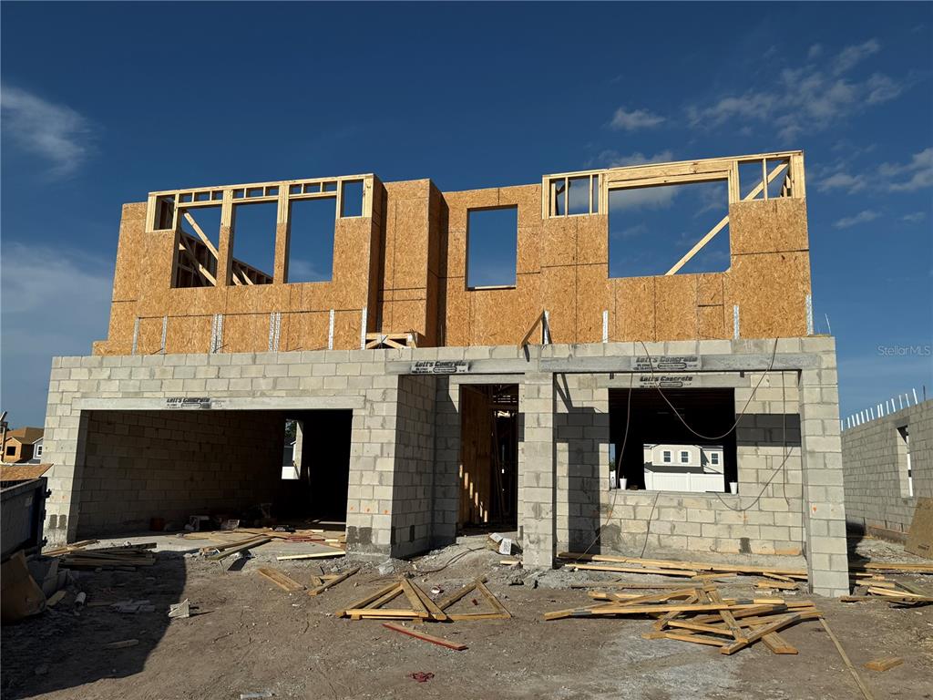 a front view of a building with glass windows and garage