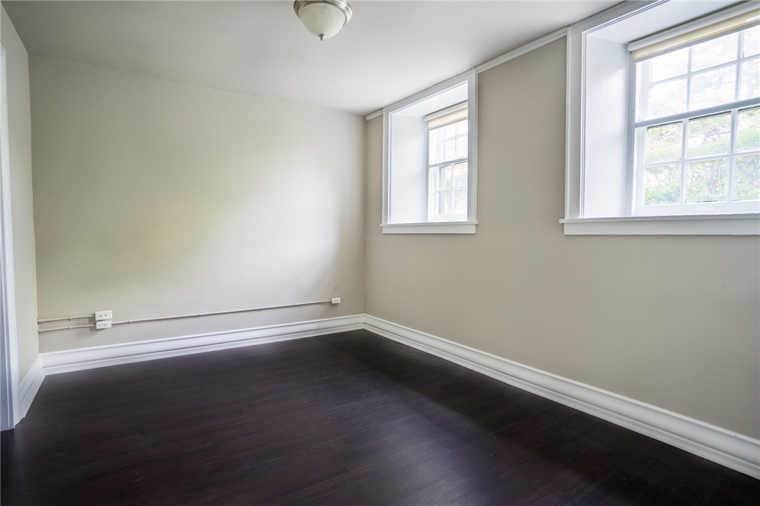300 Alexander Street, Unit 112 Rochester, NY 14607 - Photo 4 of 12 Primary bedroom with plank flooring, closets and e