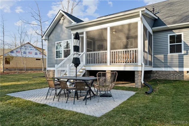 a view of a house with backyard porch and sitting area