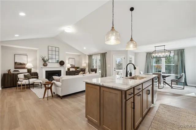 a open kitchen with stainless steel appliances granite countertop a stove and kitchen island