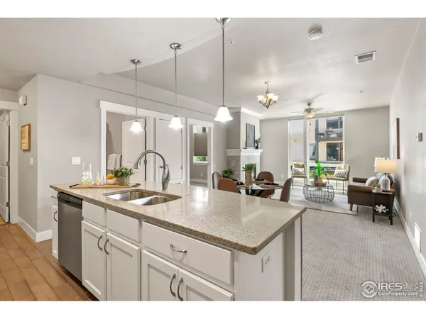 a kitchen with a sink cabinets and wooden floor