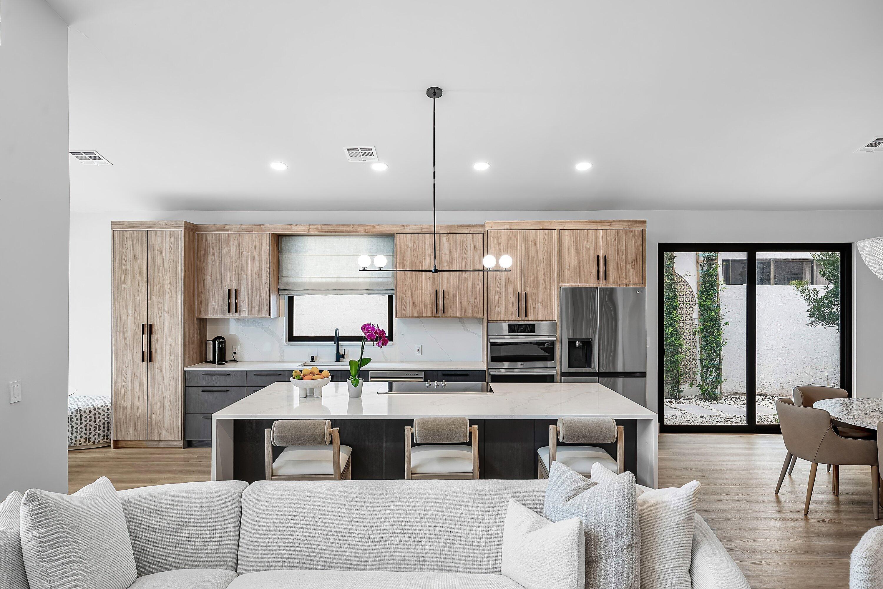 5798 Northwest 21st Avenue Boca Raton, FL 33496 - Photo 11 of 52 a living room with stainless steel appliances kitchen island granite countertop furniture and a large window