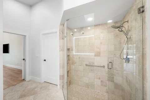 a bathroom with a glass shower door