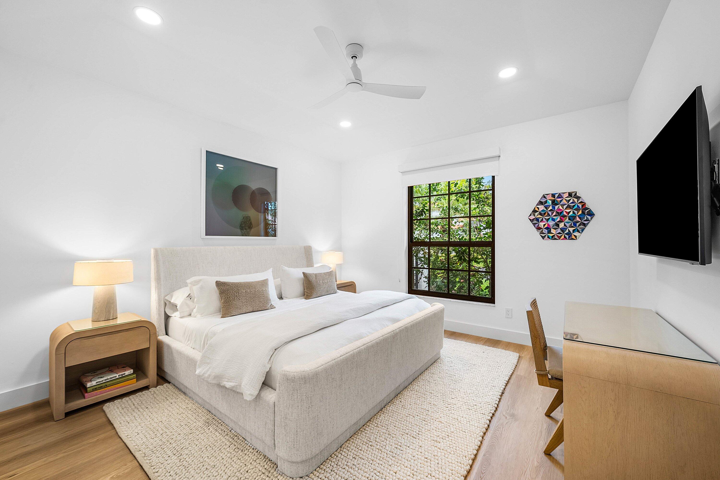 5798 Northwest 21st Avenue Boca Raton, FL 33496 - Photo 17 of 52 a bedroom with a bed and a flat screen tv