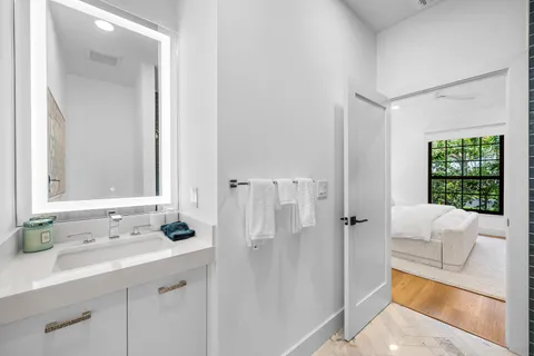 a bathroom with a tub sink and mirror