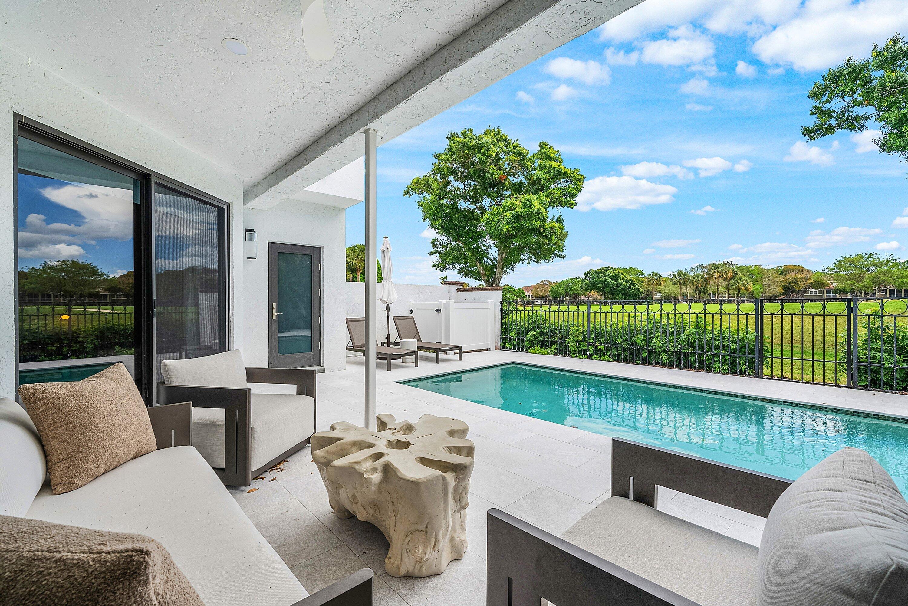 5798 Northwest 21st Avenue Boca Raton, FL 33496 - Photo 23 of 52 a balcony with furniture and garden view