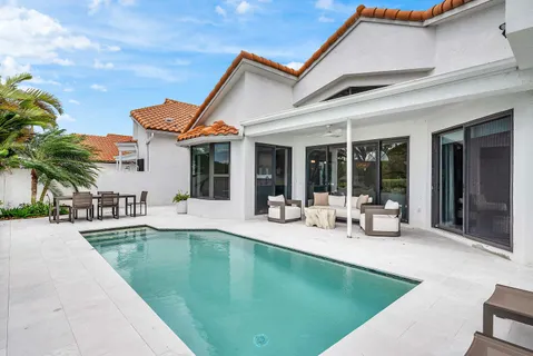 a view of a patio with swimming pool table and chairs