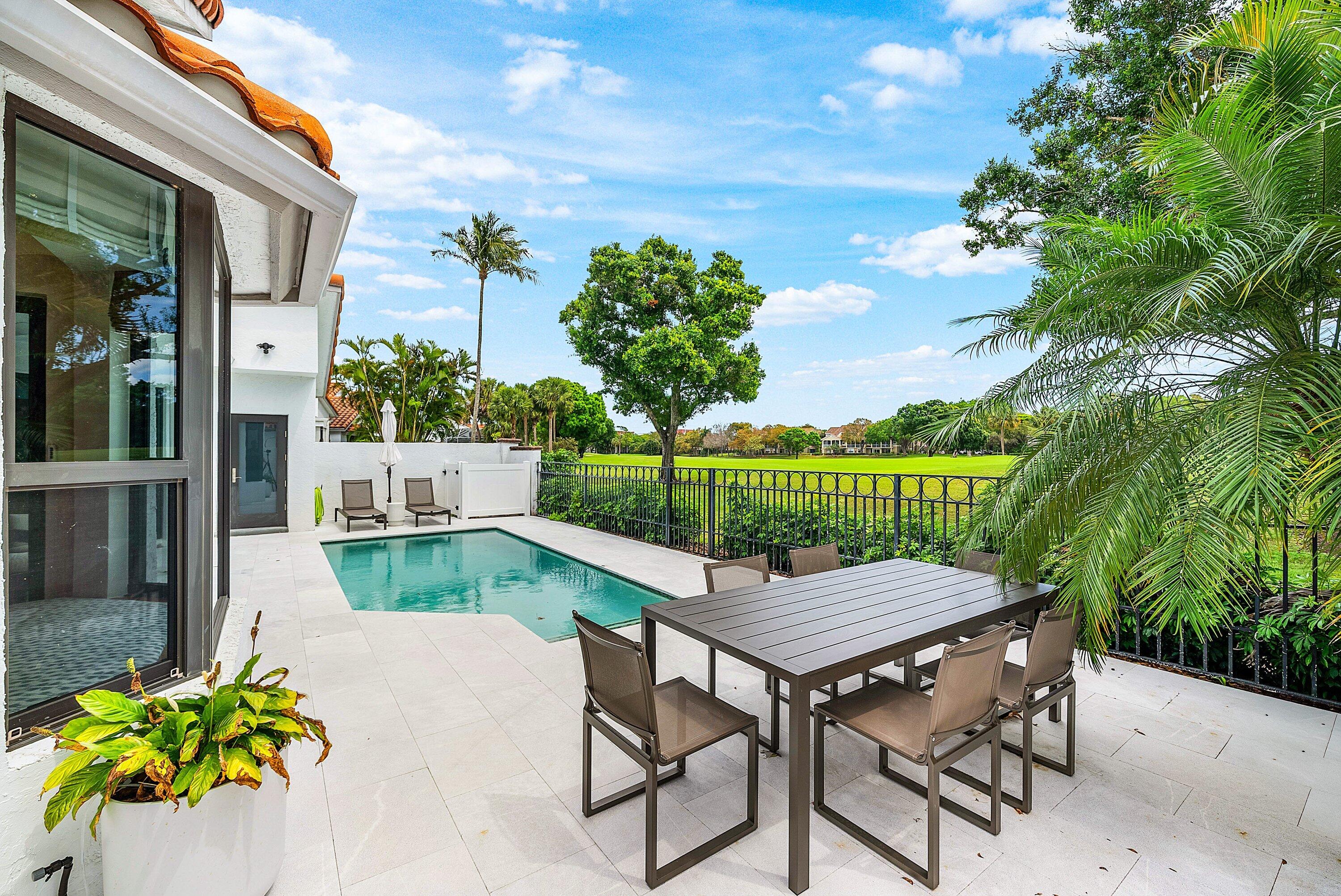 5798 Northwest 21st Avenue Boca Raton, FL 33496 - Photo 26 of 52 a view of a chairs and table in the patio