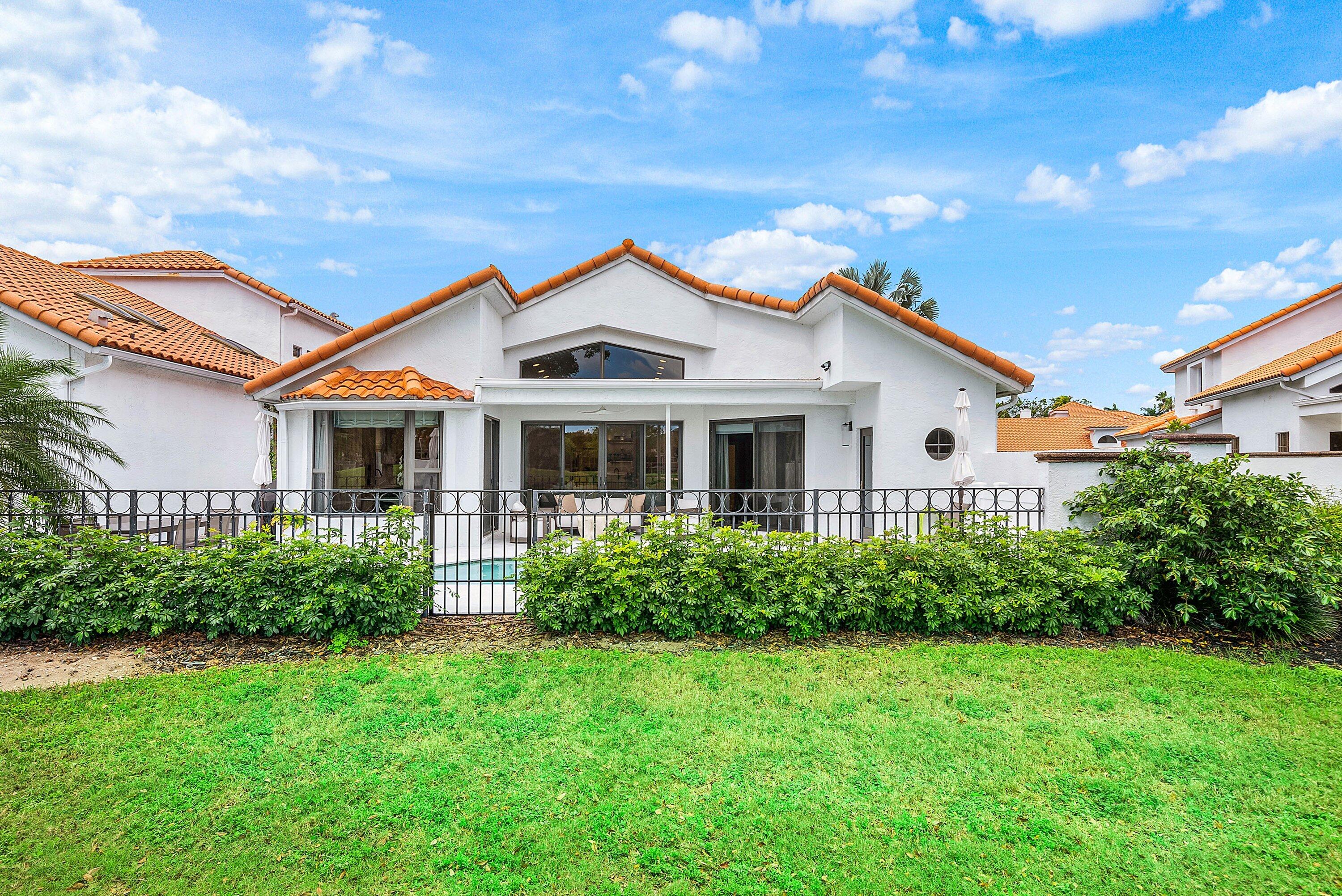 5798 Northwest 21st Avenue Boca Raton, FL 33496 - Photo 27 of 52 a front view of a house with a yard