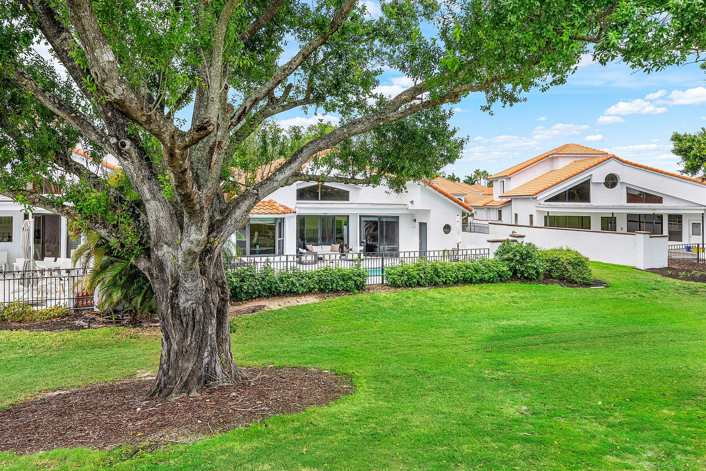 5798 Northwest 21st Avenue Boca Raton, FL 33496 - Photo 28 of 52 a front view of a house with a yard