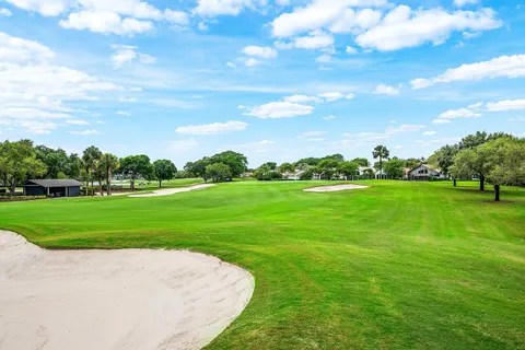 a view of grassy field with grass and trees