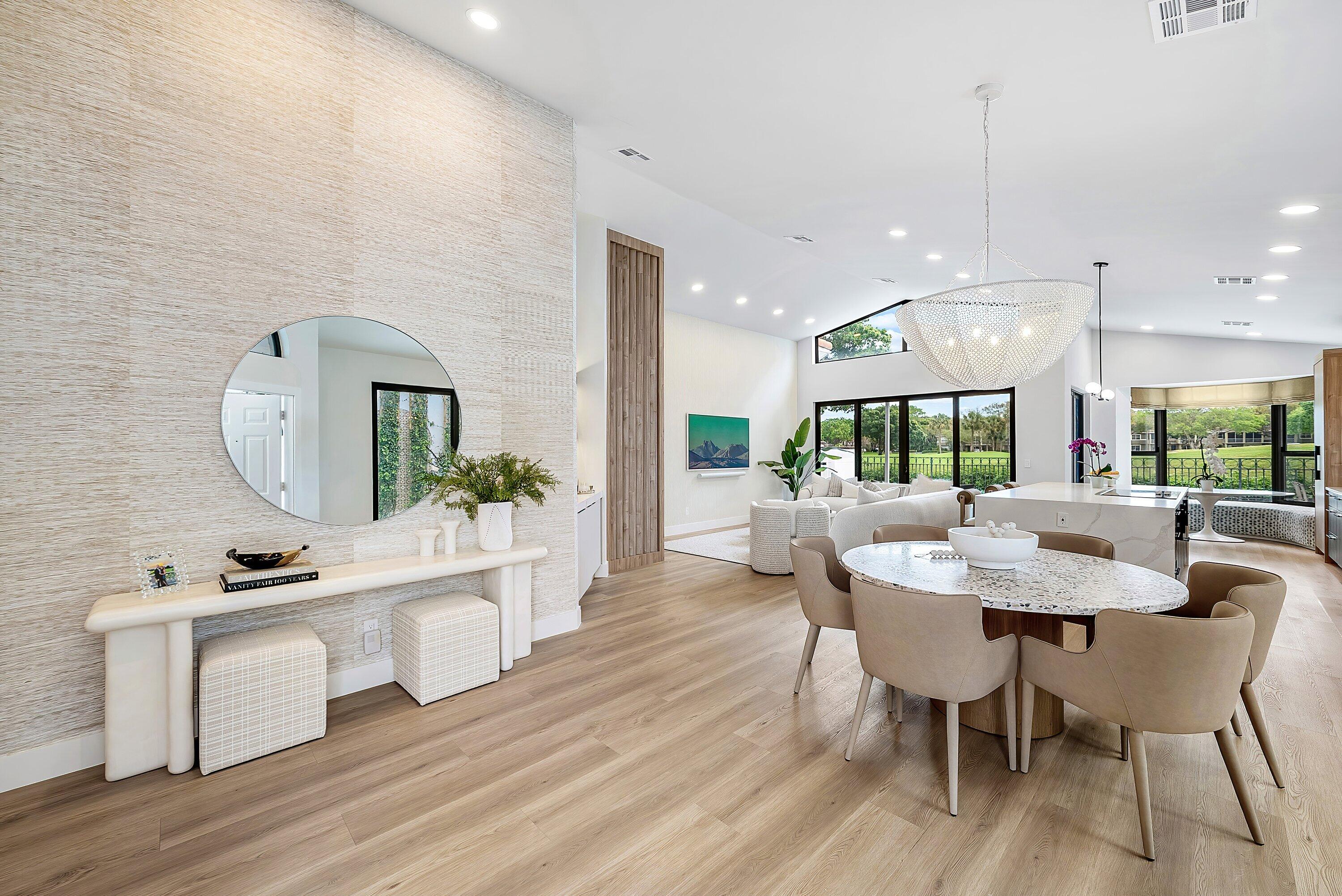 5798 Northwest 21st Avenue Boca Raton, FL 33496 - Photo 3 of 52 a dining area with a table chairs and a wooden floor