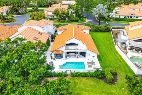 an aerial view of a house with a garden and swimming pool