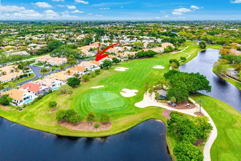 an aerial view of a residential houses with outdoor space and trees