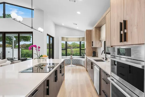 a large white kitchen with a large window