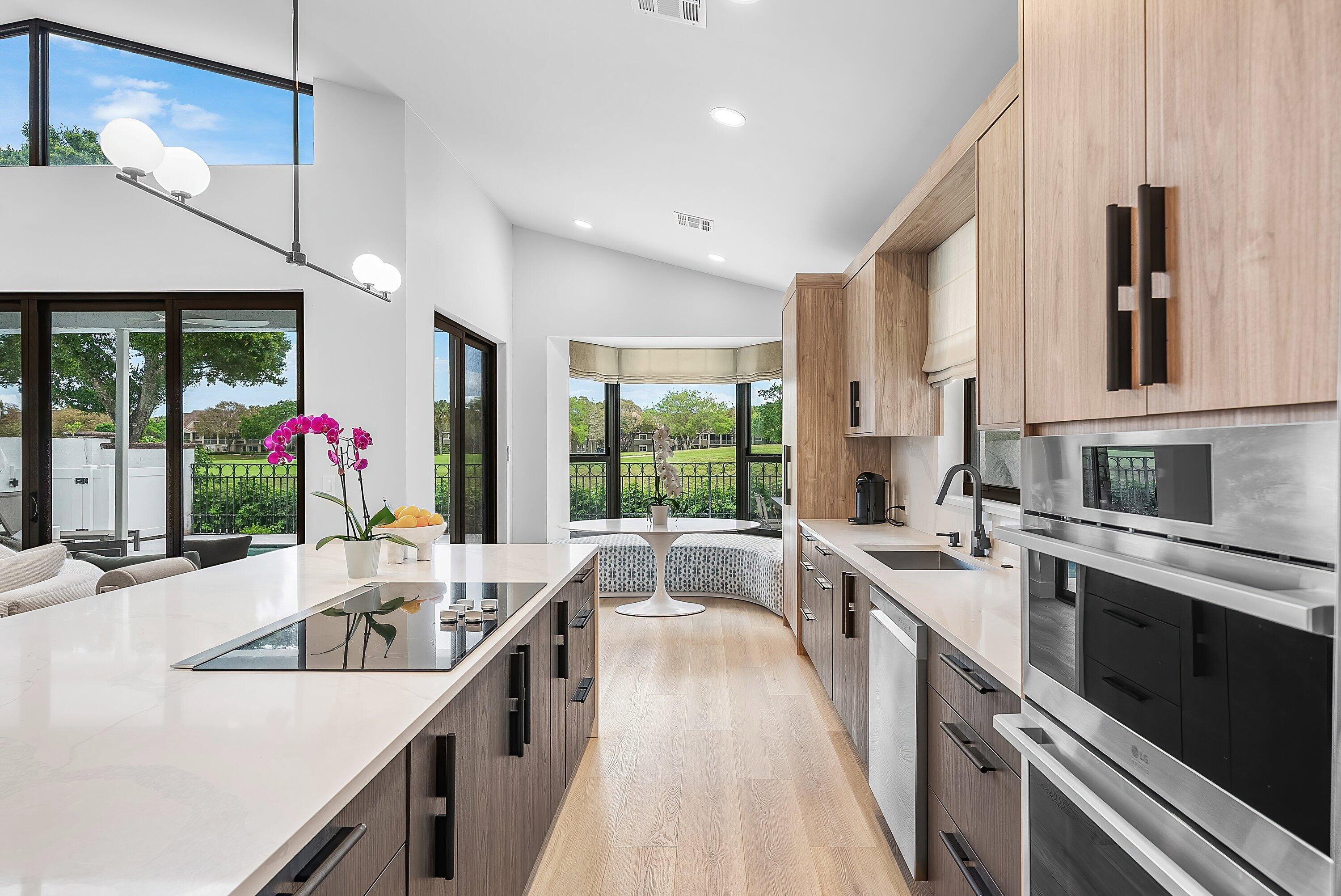 5798 Northwest 21st Avenue Boca Raton, FL 33496 - Photo 7 of 52 a large white kitchen with a large window