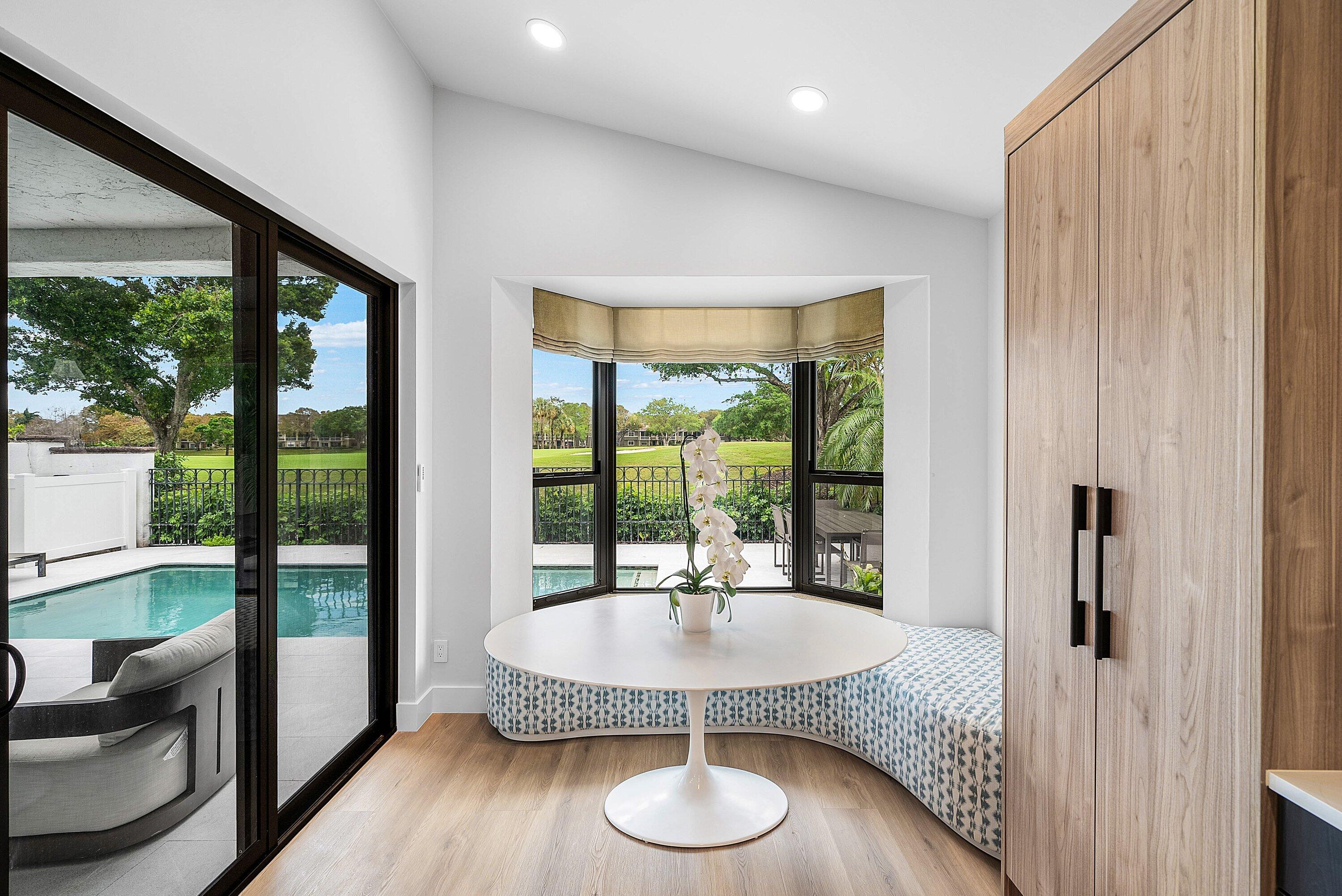 5798 Northwest 21st Avenue Boca Raton, FL 33496 - Photo 8 of 52 a dining room with furniture and wooden floor