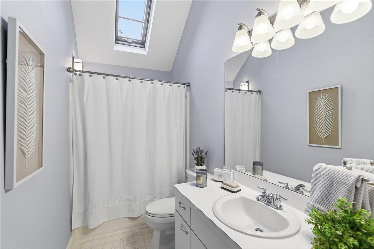 100 Mid-Iron Way, Unit 7027 Mashpee, MA 02649 - Photo 18 of 38 a bathroom with a toilet a sink and a mirror