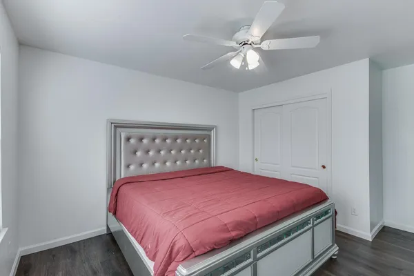 a bedroom with a large bed and a chandelier