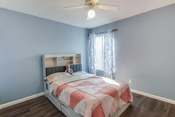 a bedroom with a bed and a chandelier