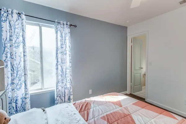 a bedroom with a bed and a window