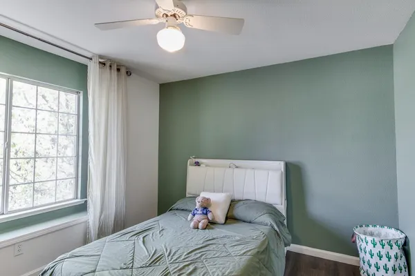 a bedroom with a bed and a window