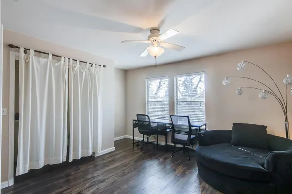 a living room with furniture and wooden floor