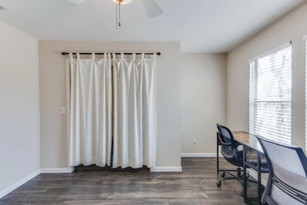 a view of a room with a window and wooden floor