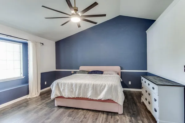 a bedroom with a bed and a window
