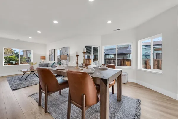 a view of a room with wooden floor and mirror