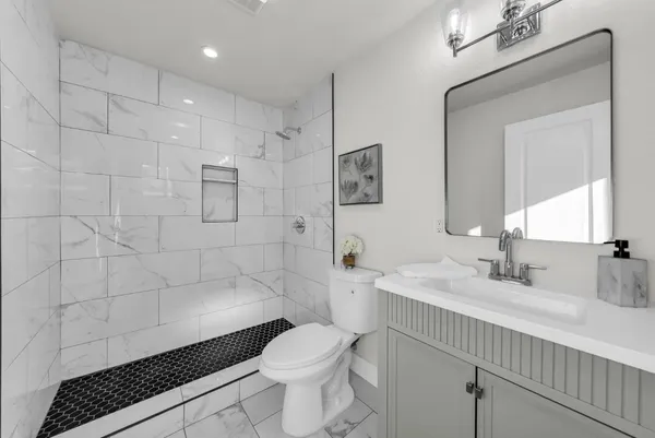 a view of an empty room with wooden floor and closet