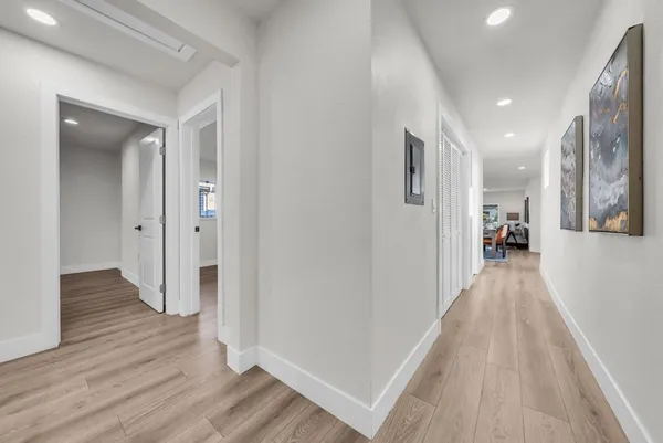 a view of empty room with wooden floor