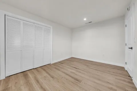 a bed room with a bed and a night stand