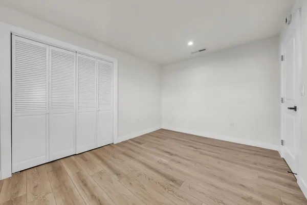 a bed room with a bed and a night stand