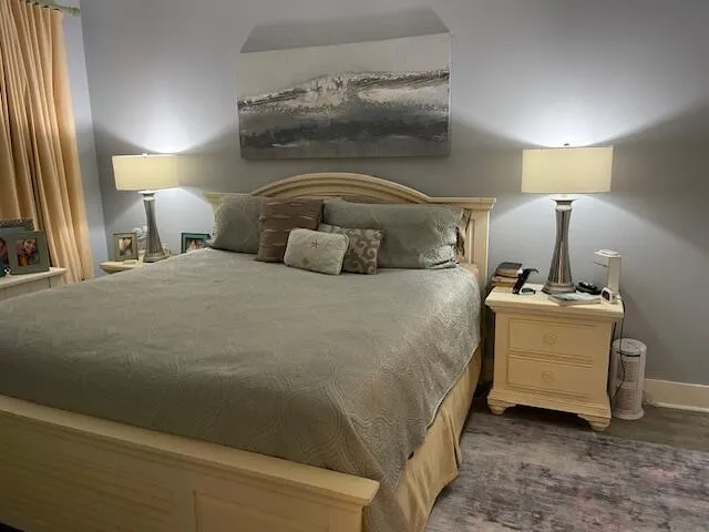 a bedroom with a bed and a lamp