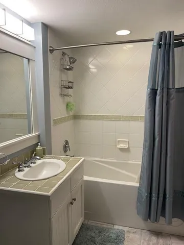 a bathroom with a sink mirror toilet and bathtub